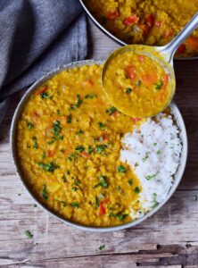 Red-Lentil-Dahl-with-rice-in-bowl-with-ladle